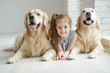 © nuzza11 - A child with an animal. Little girl with a dog at home.