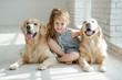© nuzza11 - A child with an animal. Little girl with a dog at home.