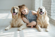 © nuzza11 - A child with an animal. Little girl with a dog at home.