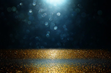 glitter abstract lights background. black, gold and blue. de-focused