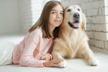 Wall Mural - Child with a dog. A girl with labradors at home.