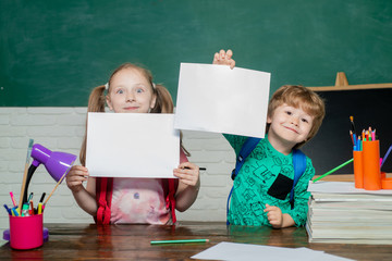 Back to school - education concept. Paper copy space. Educational process. Kids school. Kid is learning in class on background of blackboard.