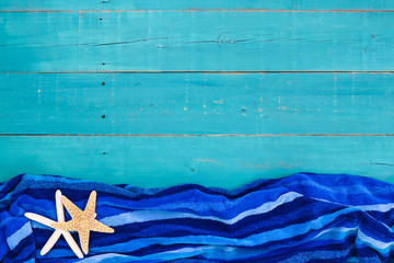 Wall Mural - Blank teal blue wood sign with beach towel and starfish border