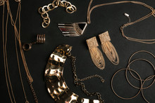 Set Of Gold Jewelry On Black Background, Flat Lay