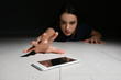 © New Africa - Lonely woman reaching out for smart phone on floor indoors. Internet addiction