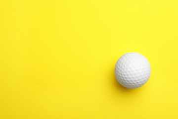 Poster - Golf ball on color background, top view. Space for text