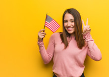 Young Cute Woman Holding An United States Flag Fun And Happy Doing A Gesture Of Victory