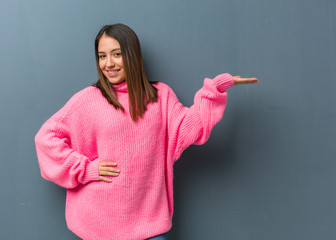 Wall Mural - Young modern woman holding something with hand