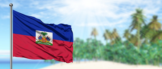 Wall Mural - Waving Haiti flag in the sunny blue sky with summer beach background. Vacation theme, holiday concept.