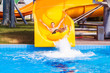 © Svetlana - Funny excited man enjoying summer vacation in water park riding yellow float laughing.