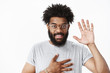 © Cookie Studio - Friendly nice african american man at meeting holding palm on chest and raising hand in hello, meeting new people, greeting trying make new friends smiling sincere at camera, introducing himself