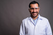 © Ranta Images - Handsome bearded Persian man doctor wearing protective glasses a