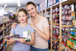 © JackF - Woman with girl in school supplies shop