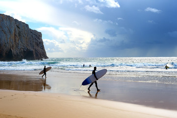 Wall Mural - Surfers surfboards beach rain Portugal