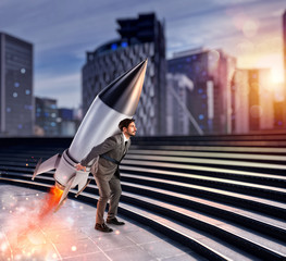 Wall Mural - Determination and power businessman that holds a rocket. Startup concept