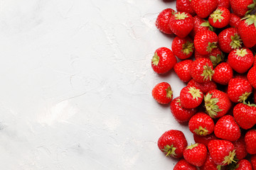 Flat lay composition with with tasty ripe strawberries on light background