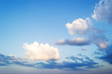 Wall Mural - beautifull skyscape at evening. fluffy white and blue clouds high in a bright blue sky. crystal clea