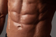 © Restyler - Male abdominal muscles closeup with sweat drops after exercise