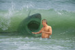 © Michael O'Keene - Frightened swimmer man getting hit by wave with attacking shark