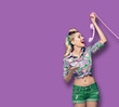 © vgstudio - Photo of young excited happy woman with phone, dressed in pinup style, over violet color background