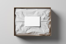 Open Gift Box With White Wrapping Paper And Business Card On A Light Background. Business Gift. Mock Up. Top View. 3d Rendering