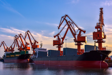 Heavy Loader Working in a Harbour in the Background of Sunset