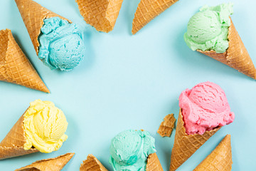 Pastel ice cream in waffle cones, bright background, copy space