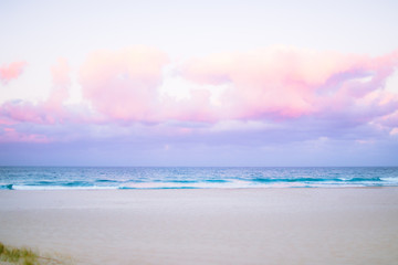 Wall Mural - pretty pastel colour sky pink purple blue with fluffy cloud on beach 
