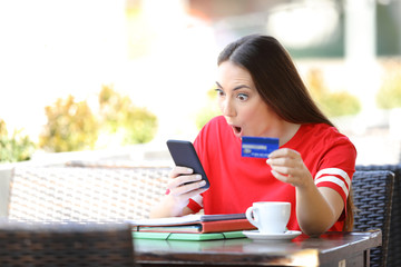 Poster - Shocked student paying online with credit card in a bar