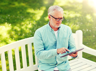 Wall Mural - technology, senior people, and lifestyle, distance learning concept - old man with tablet pc computer at summer park