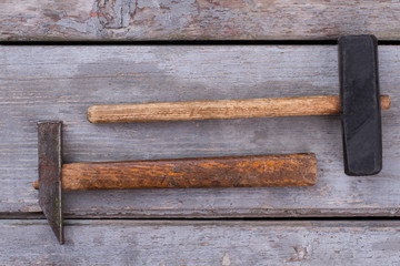 Wall Mural - Two hammers on wooden background. Tools for construction or repair. Vintage style.