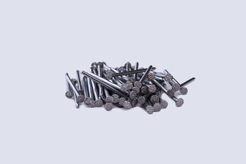 Wall Mural - Pile of metal nails on a white background. Tool for repair. Construction and building concept.