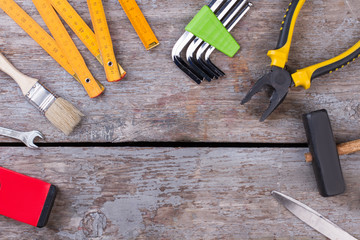 Set of different building instruments and copy space. Instruments set for hand work and repairing. Rustic boards background.