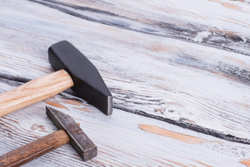 Wall Mural - Two different hammers on wooden background. Big and small hammers on wooden boards. Space for text.