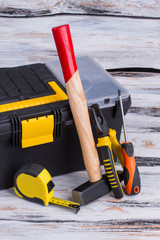 Tool kit on wooden background. Tool box, hammer, measuring tape, pliers and scewdriver. Repair concept.