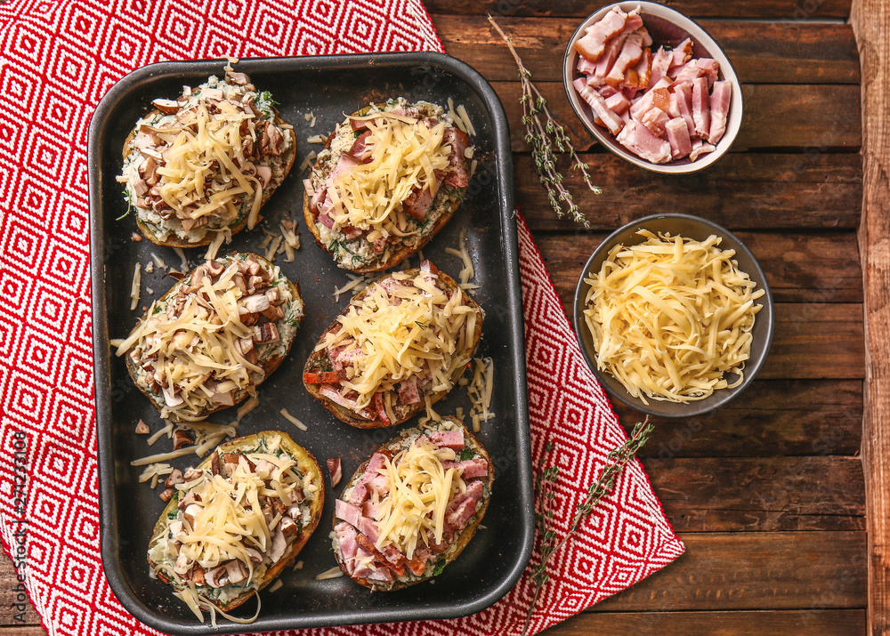 Plate with tasty stuffed potato on wooden background