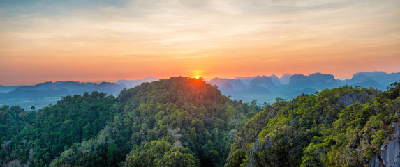 Wall Mural - Panorama of tropicall landscape with dramatic sunset and steep mountain ridge on horizon. Krabi, Thailand