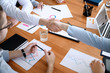 © Pixel-Shot - Young businessmen shaking hands at meeting in office