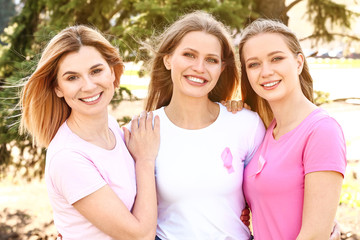 Sticker - Beautiful women of different ages with pink ribbons outdoors. Breast cancer concept