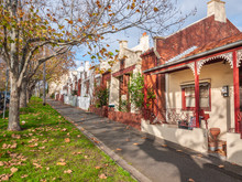 Pedestrian Sidewalk And Victorian Style Houses In A Quiet Neighbourhood Street. View Of A Melbourne's Old Residential Suburb. North Melbourne, VIC Australia.