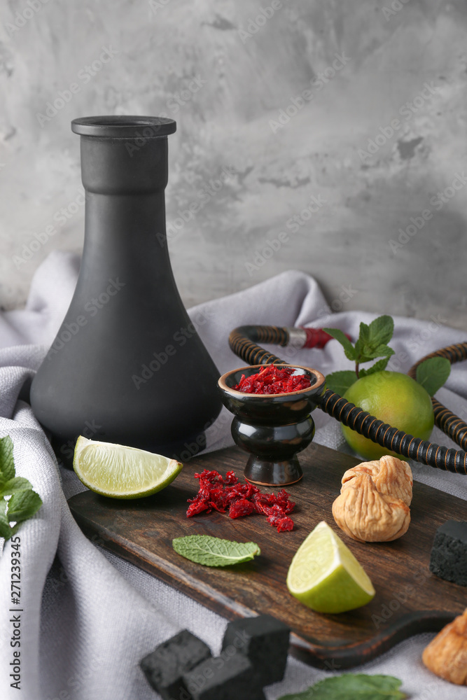 Hookah with tobacco, coal and fresh fruits on table