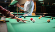 © Pixel-Shot - Young women playing billiard in club