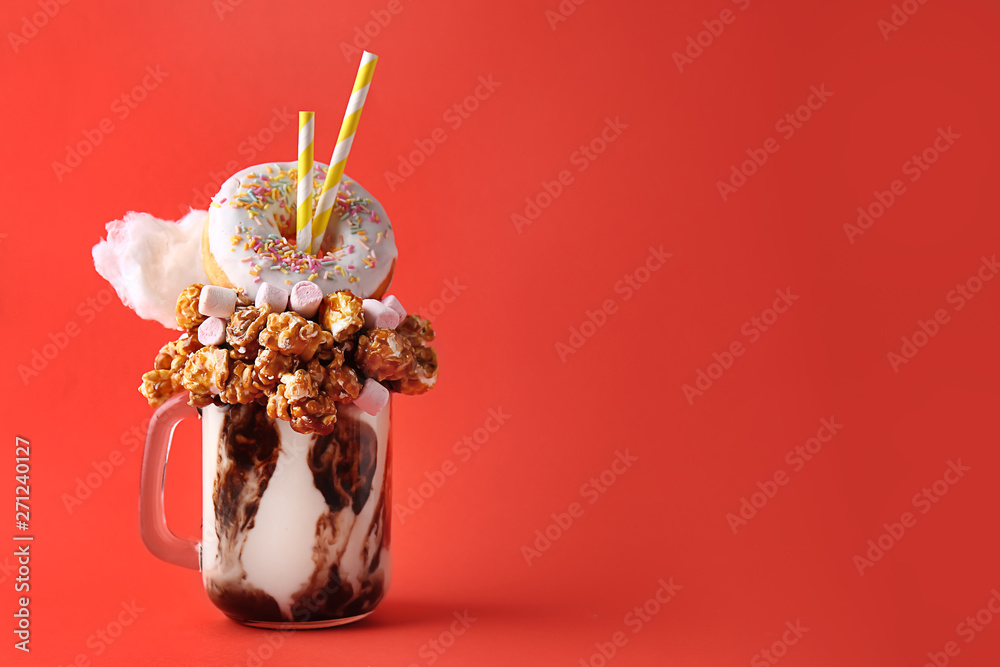 Delicious freak shake on color background