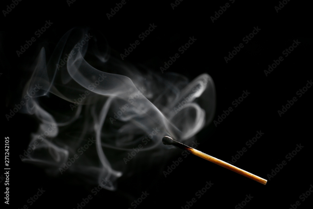 Burnt out match on dark background