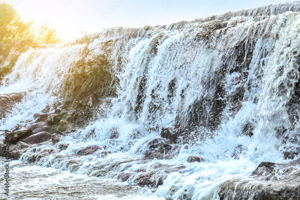 Beautiful waterfall in countryside on summer day