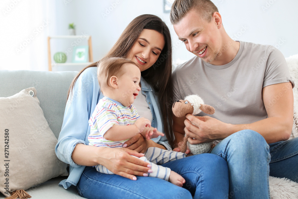 Happy parents with cute little baby at home