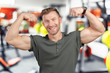 © fotofabrika - smiling man showing biceps