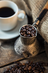 coffee beans and turk on a wooden background