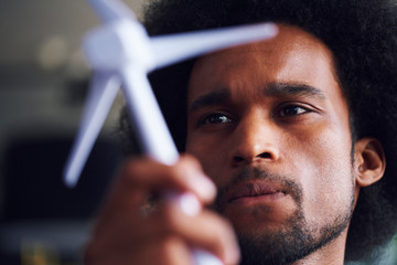 Close up of African man with wind turbine