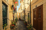 Fototapeta Uliczki - A narrow street in Alfama district in Lisbon, Portugal